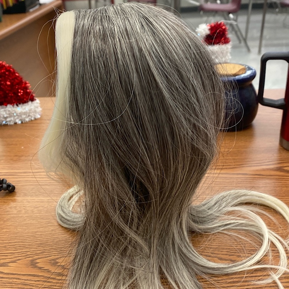 I am selling a brand new wig it’s white  and gray in color with clips